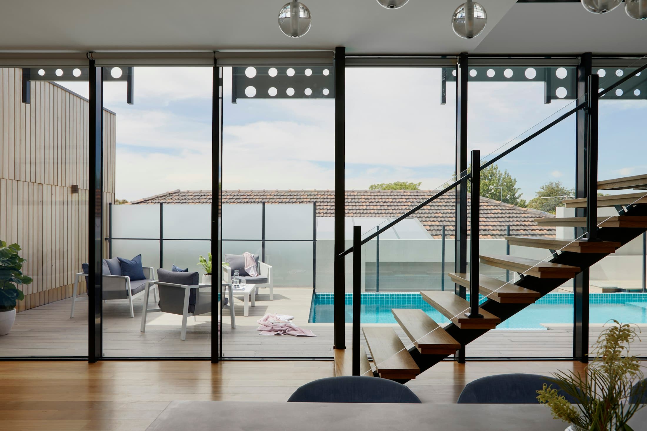 Light-filled living room opening onto a pool terrace