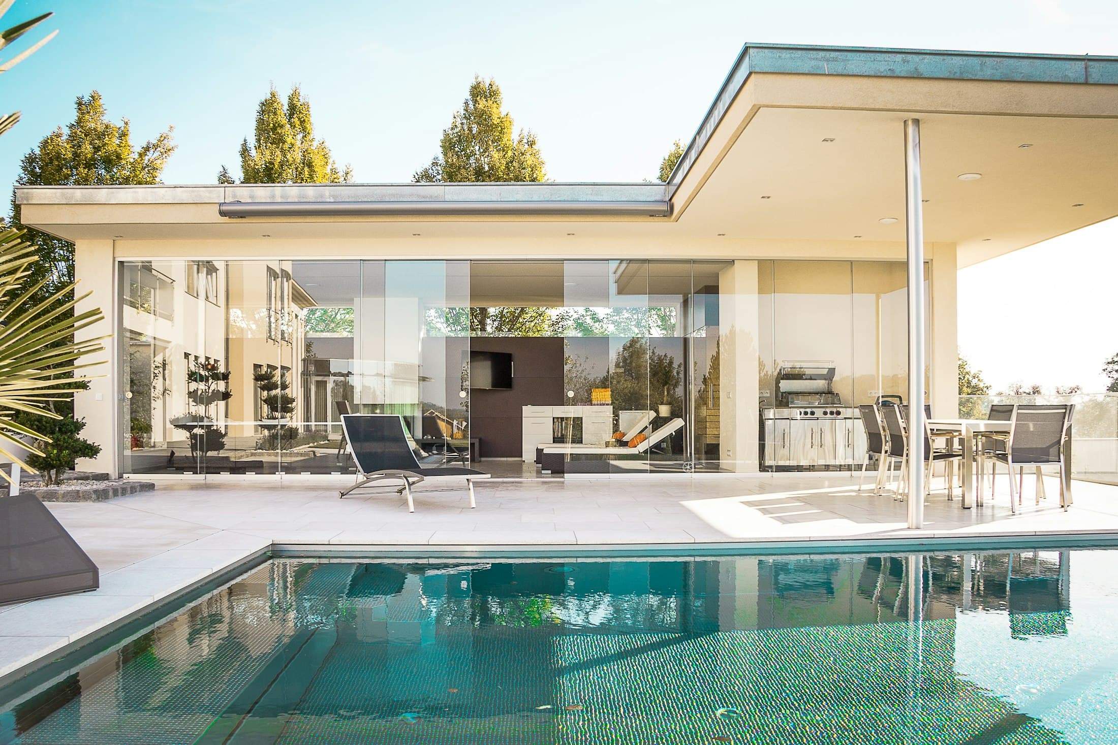 Villa terrace with pool and palm trees